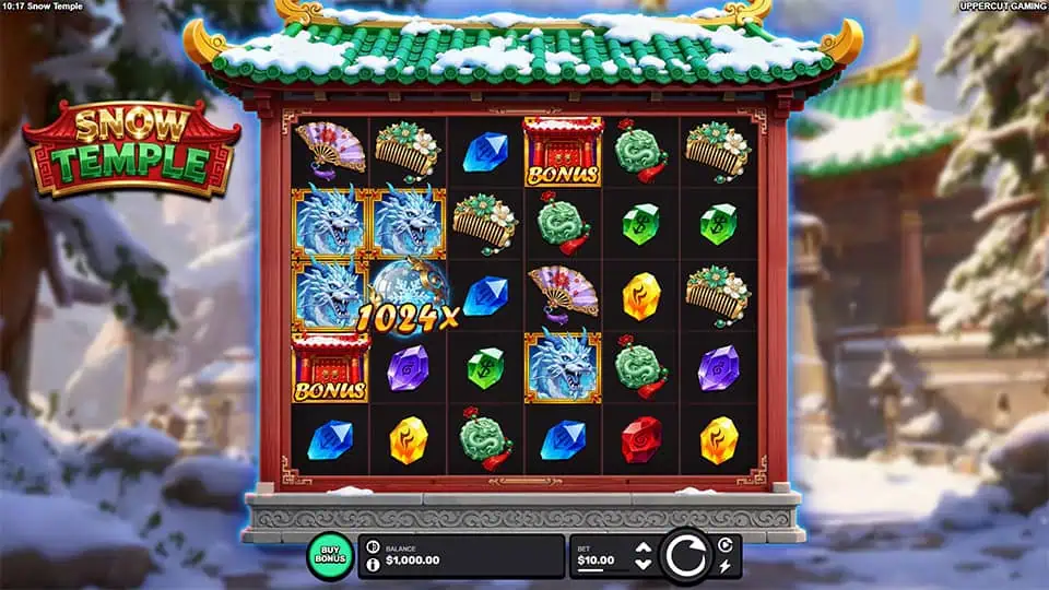 Snow Temple gameplay screen with dragon, gem, and fan symbols on a large reel grid set in a winter temple scene.